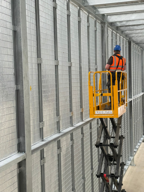 A worker on a cherry picker.
